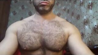 Hairy hunk plays with his big cock