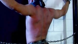 Muscled Derek Pain takes flogging all over his sexy back til it is rosy red