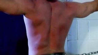 Muscled Derek Pain takes flogging all over his sexy back til it is rosy red