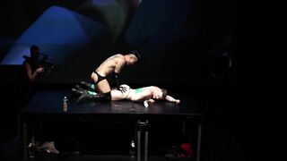 Axel Abysse and Yoshi Kawasaki take the stage for a live sex show in an unusual venue