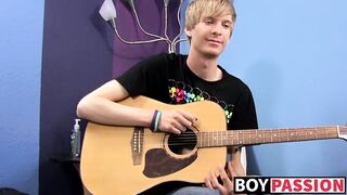 Young man plays guitar before dick stroking and cumming