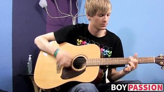 Young man plays guitar before dick stroking and cumming