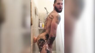 Tattooed Wolf Romps Faux-Cock in Bathroom Until He Spunks