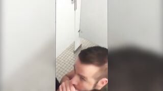 Handsome guy sucks dick in restroom stall