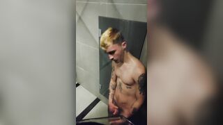 young fellow demonstrating off in the gym bathroom