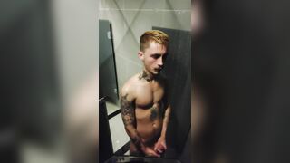 young fellow demonstrating off in the gym bathroom