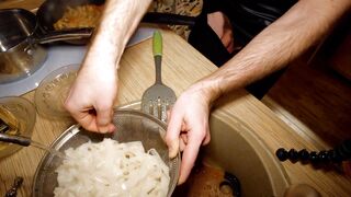 Beautiful cooking. Bare shirtlifter chef is cooking rice noodle with chicken and vegetables