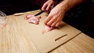 Beautiful cooking. Bare shirtlifter chef is cooking rice noodle with chicken and vegetables