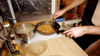 Beautiful cooking. Bare shirtlifter chef is cooking rice noodle with chicken and vegetables