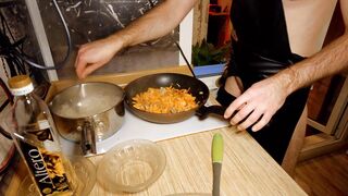 Beautiful cooking. Bare shirtlifter chef is cooking rice noodle with chicken and vegetables