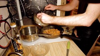 Beautiful cooking. Bare shirtlifter chef is cooking rice noodle with chicken and vegetables