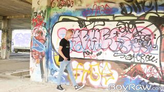 Young guy masturbates in public in front of graffiti wall