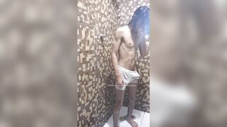 Bony teenager is taking douche in white trunks