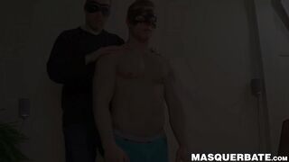 Masked hunk jerks off while caressed by his buddy