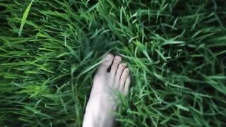 Jon Arteen in brief cutoffs ambles on grass bootless, displays his fellow feet, grins for you