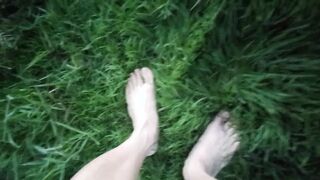 Jon Arteen in brief cutoffs ambles on grass bootless, displays his fellow feet, grins for you