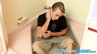 Muscular jock plays with his cock while taking nice bath