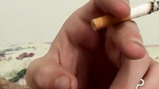 Inked skinny dude plays with himself while smoking